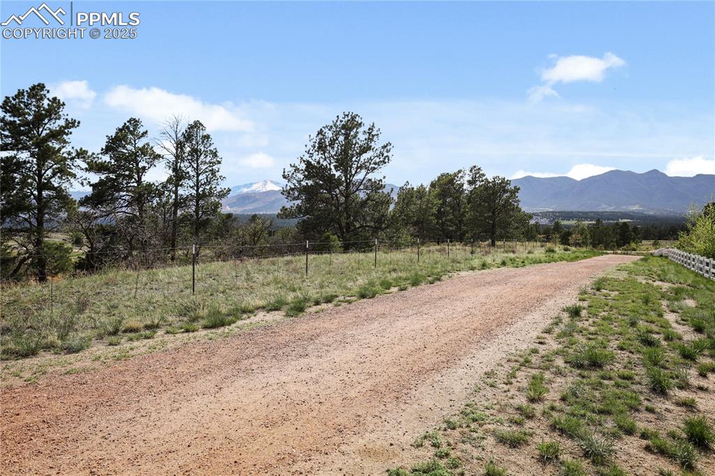 Image 47 of 50: View of dirt / gravel road featuring a mountain view and a rural view