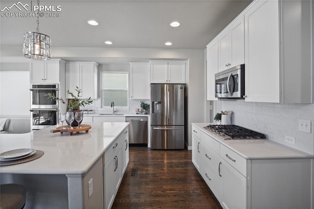 Image 5 of 50: Kitchen with appliances with stainless steel finishes, a sink, recessed lig