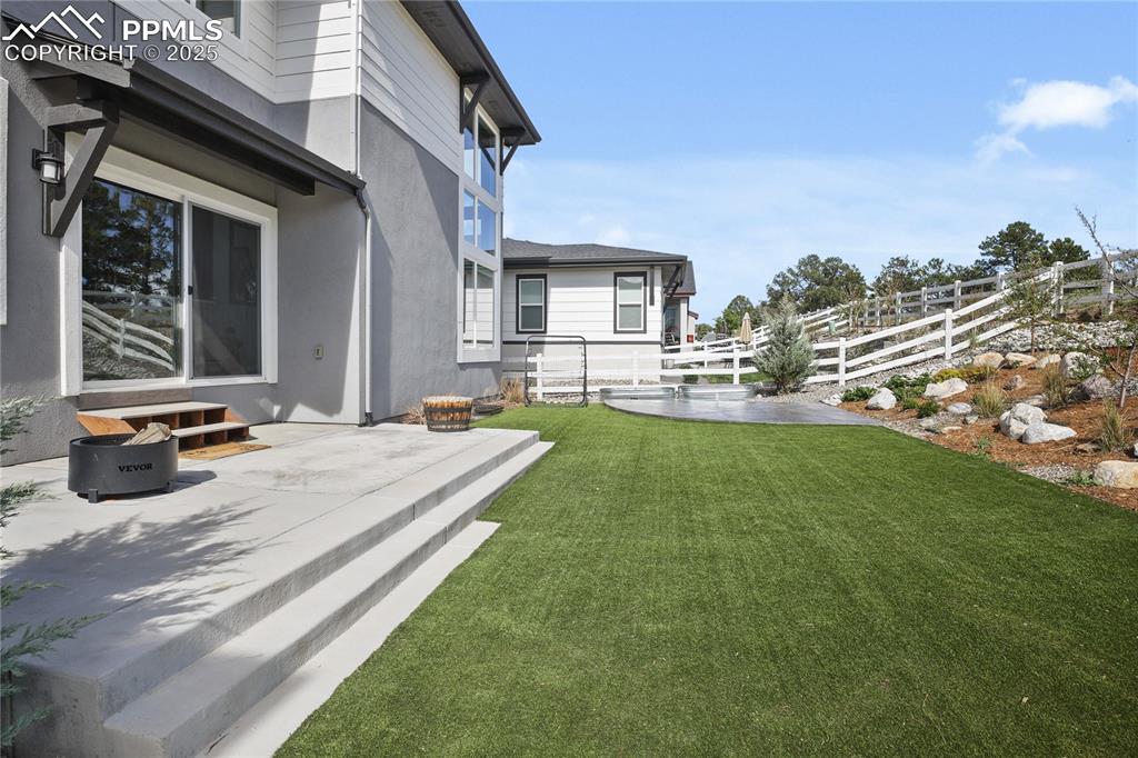 Image 50 of 50: View of yard featuring a patio area and entry steps
