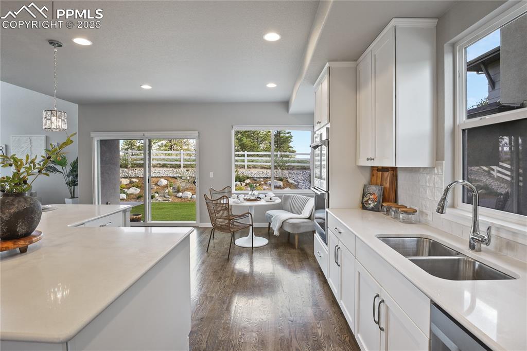 Image 6 of 50: Kitchen with a sink, recessed lighting, dark wood-style flooring, and light
