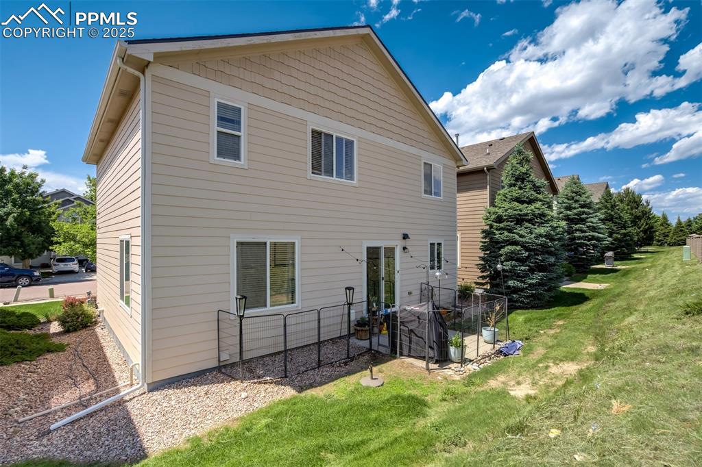 Image 26 of 28: Backyard area that is also maintained for you.