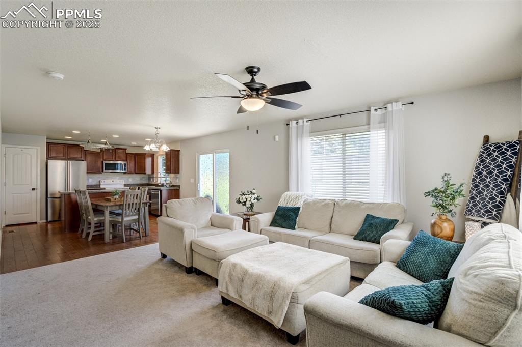 Image 6 of 28: Living room is open to the dining area & kitchen. 