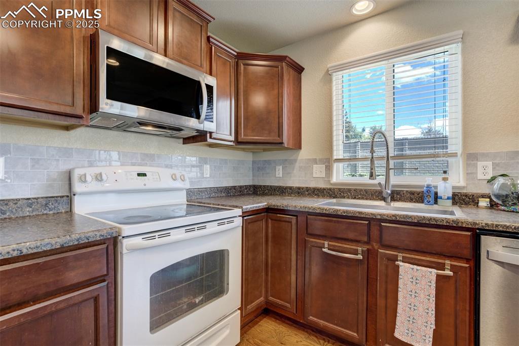 Image 7 of 28: Nice Birchwood cabinets, backsplash, and new single-bowl sink & faucet. 