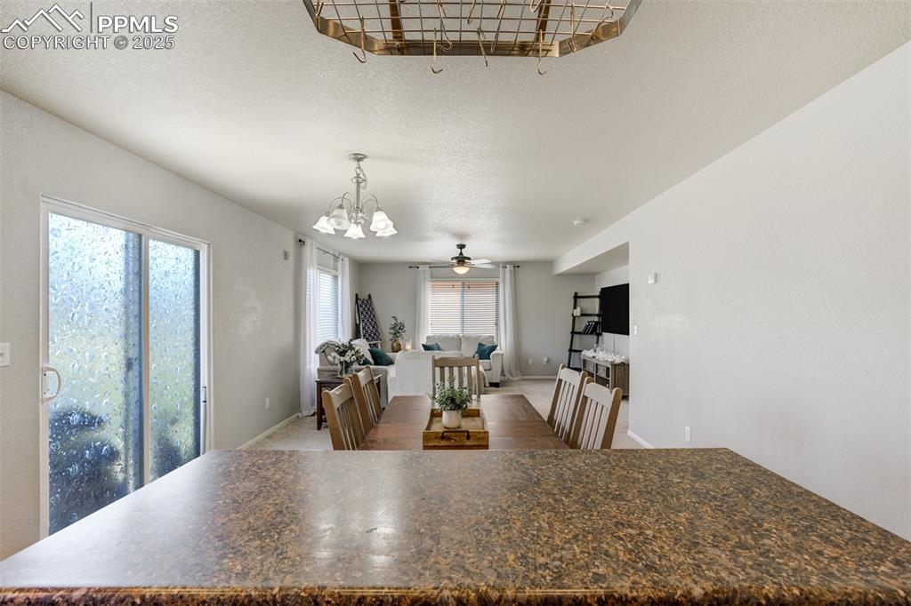 Image 9 of 28: Kitchen island looking out into the living room. 