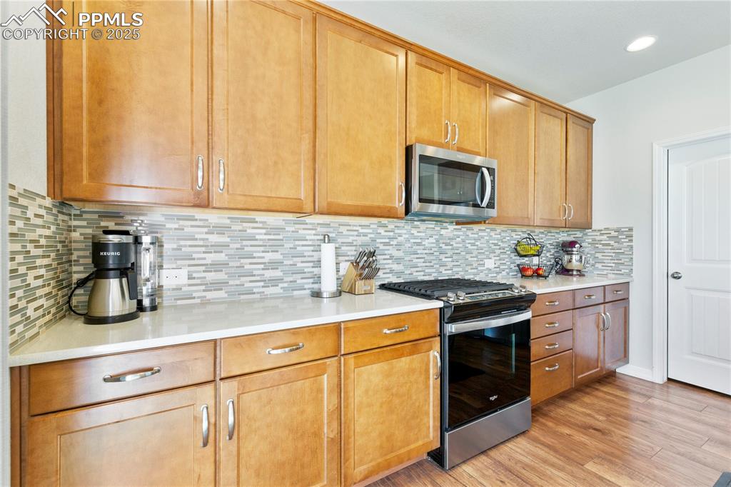 Image 11 of 38: Custom tile backsplash in kitchen