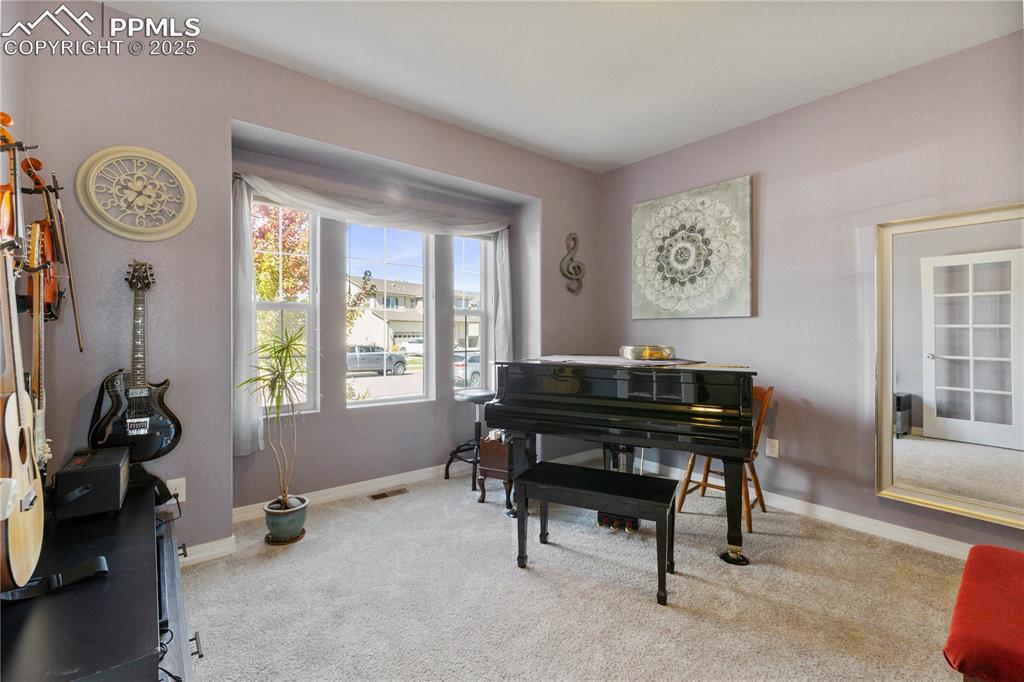 Image 13 of 38: Office on main level currently used as a music room