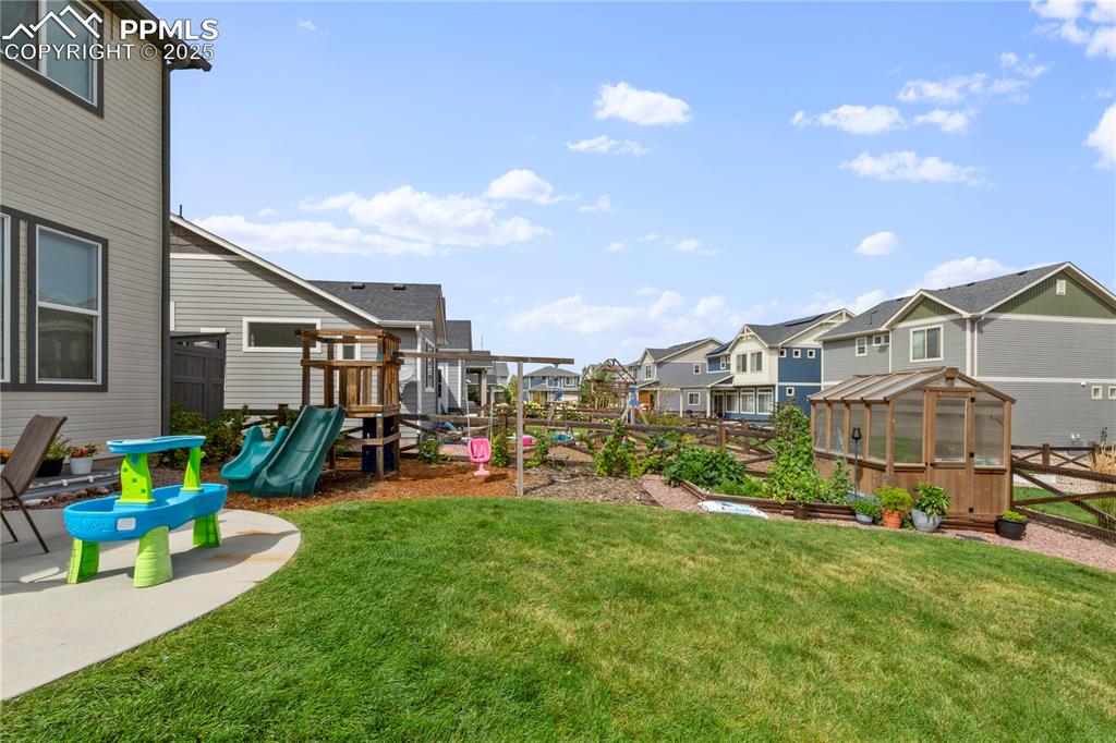 Image 30 of 38: Greenhouse and playset are included