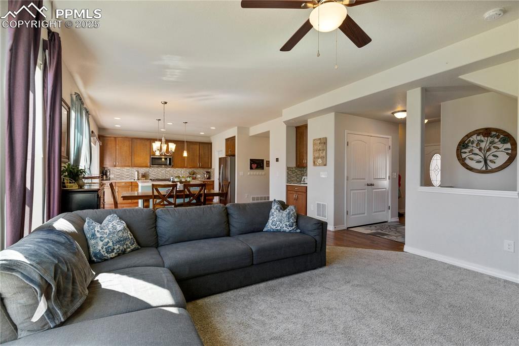 Image 4 of 38: Living room opens to the kitchen