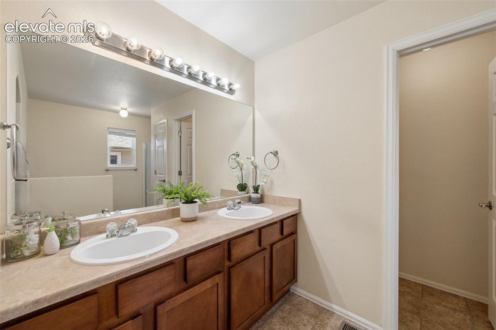 Image 12 of 33: Primary Bedroom En-Suite With Double Sink