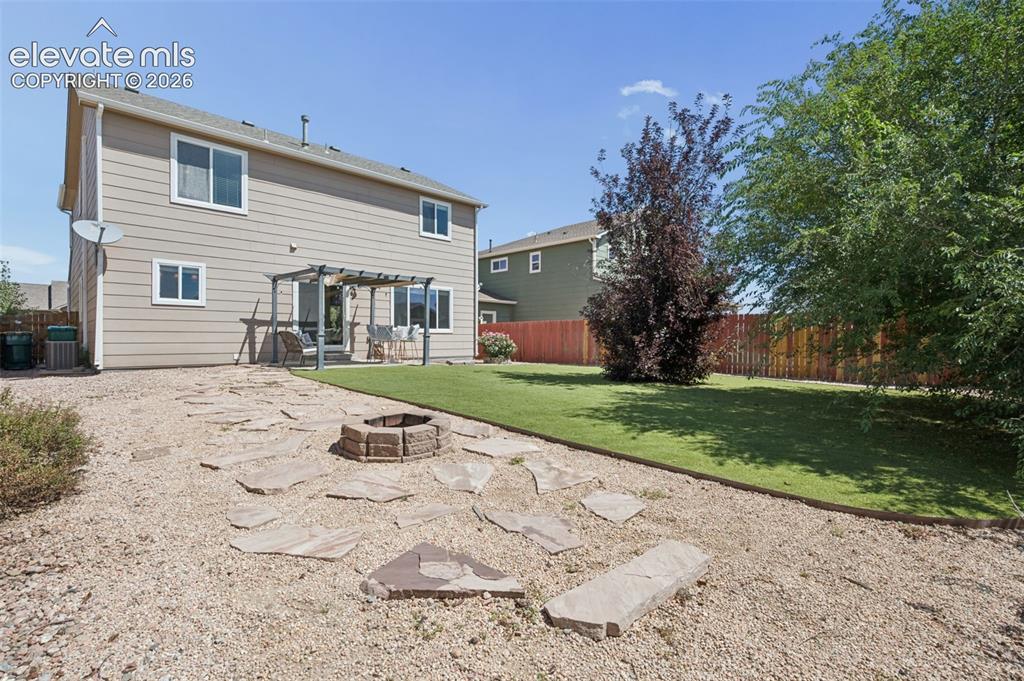 Image 30 of 33: Huge Fenced In Backyard with Fire Pit