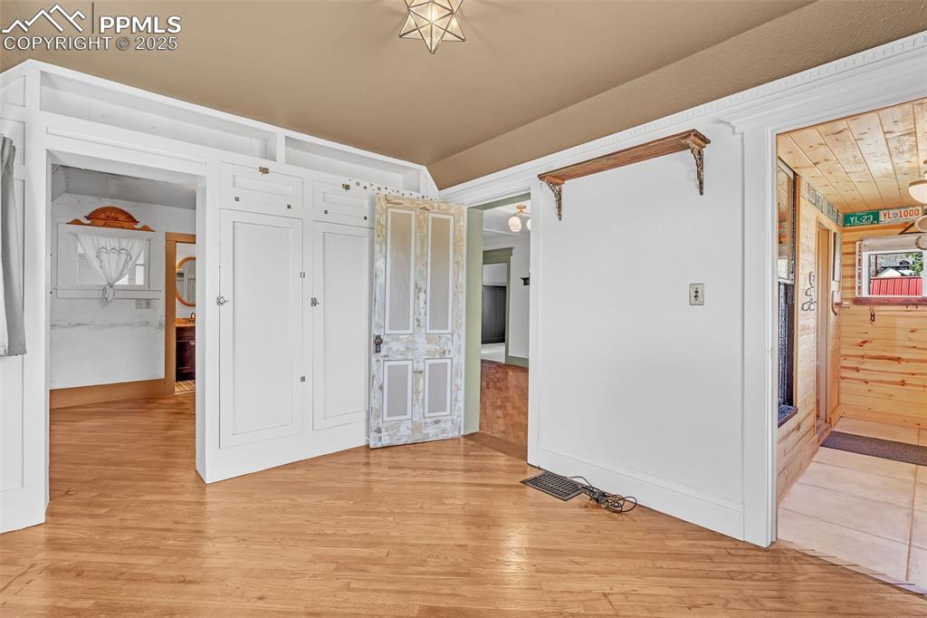 Image 15 of 50: Main bedroom featuring light wood-type flooring going into the closet and a