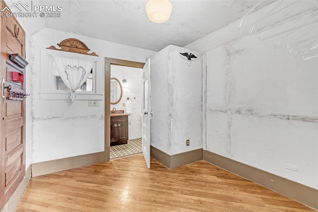 Image 16 of 50: Extra large closet off main bedroom with access to 3/4 bath and featuring w