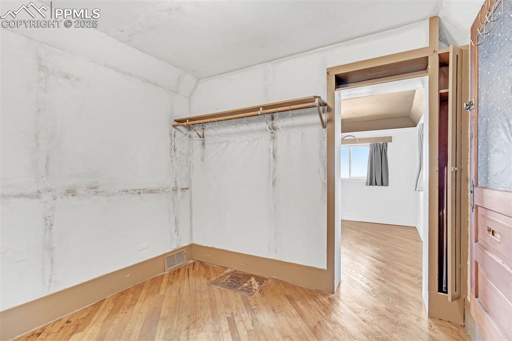 Image 17 of 50: Extra Large walk in closet off the main bedroom featuring light wood-style