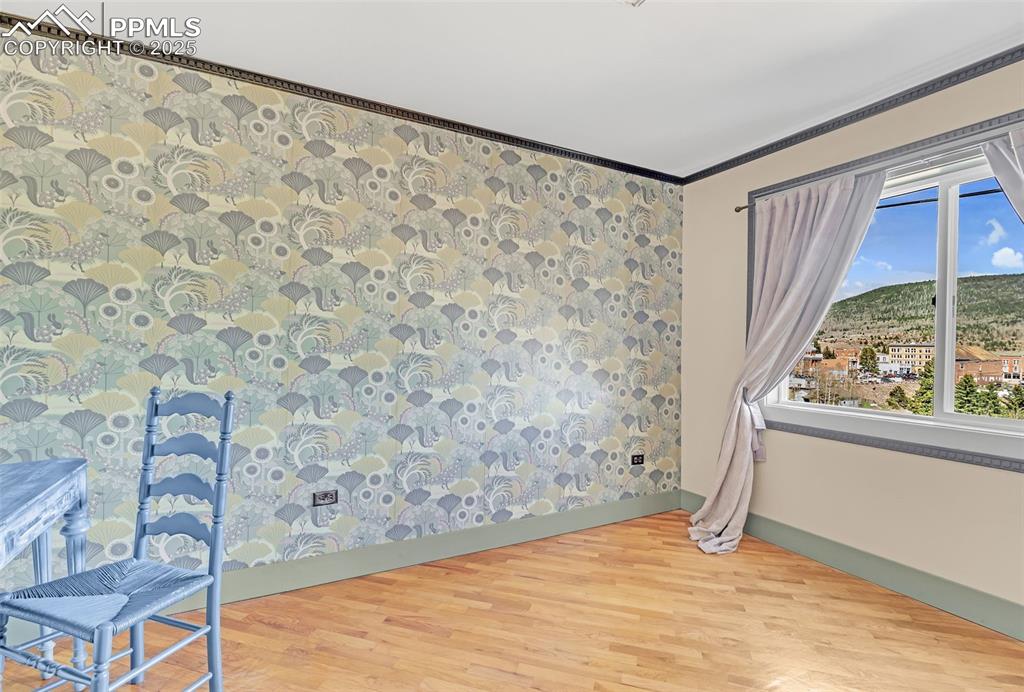 Image 22 of 50: Bedroom featuring light wood-style flooring, baseboards, plenty of natural