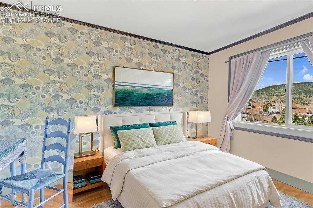 Image 23 of 50: Virtually Staged Bedroom featuring light wood-style flooring, baseboards, p