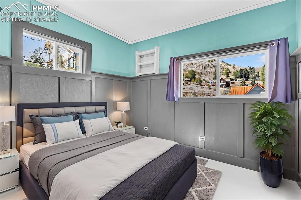 Image 27 of 50: Virtually Staged Bedroom featuring a decorative wall and wainscoting
