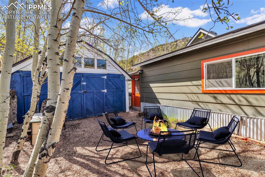 Image 42 of 50: Virtually Staged fenced back yard with access to detached garage.
