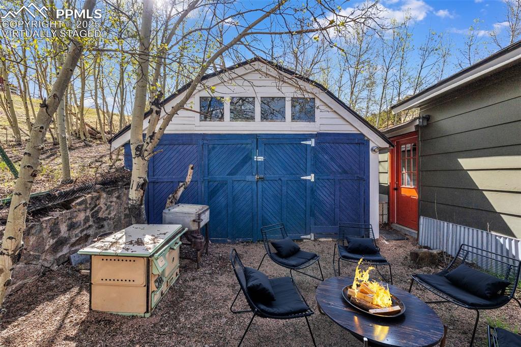 Image 45 of 50: Virtually Staged Back yard with access to Garage
