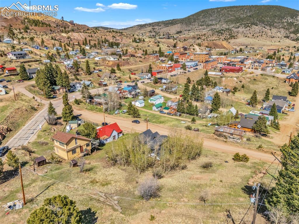 Image 47 of 50: Aerial view of residential area featuring town of Victor and surrounding mo
