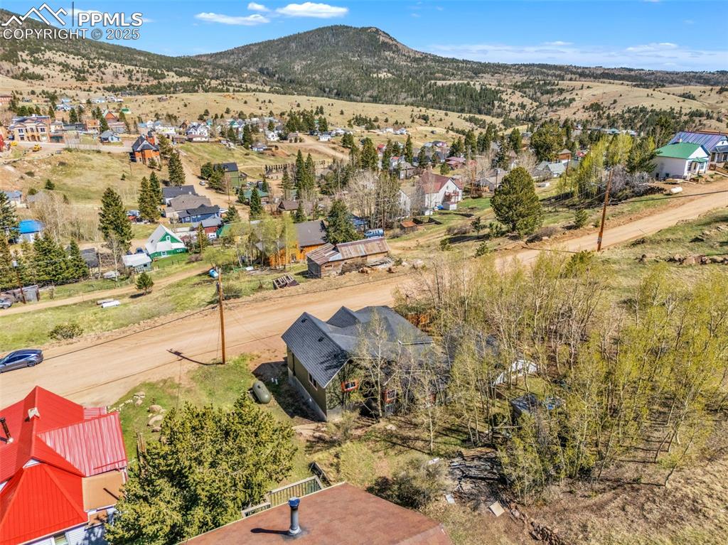Image 48 of 50: Aerial view of residential area with a mountain backdrop