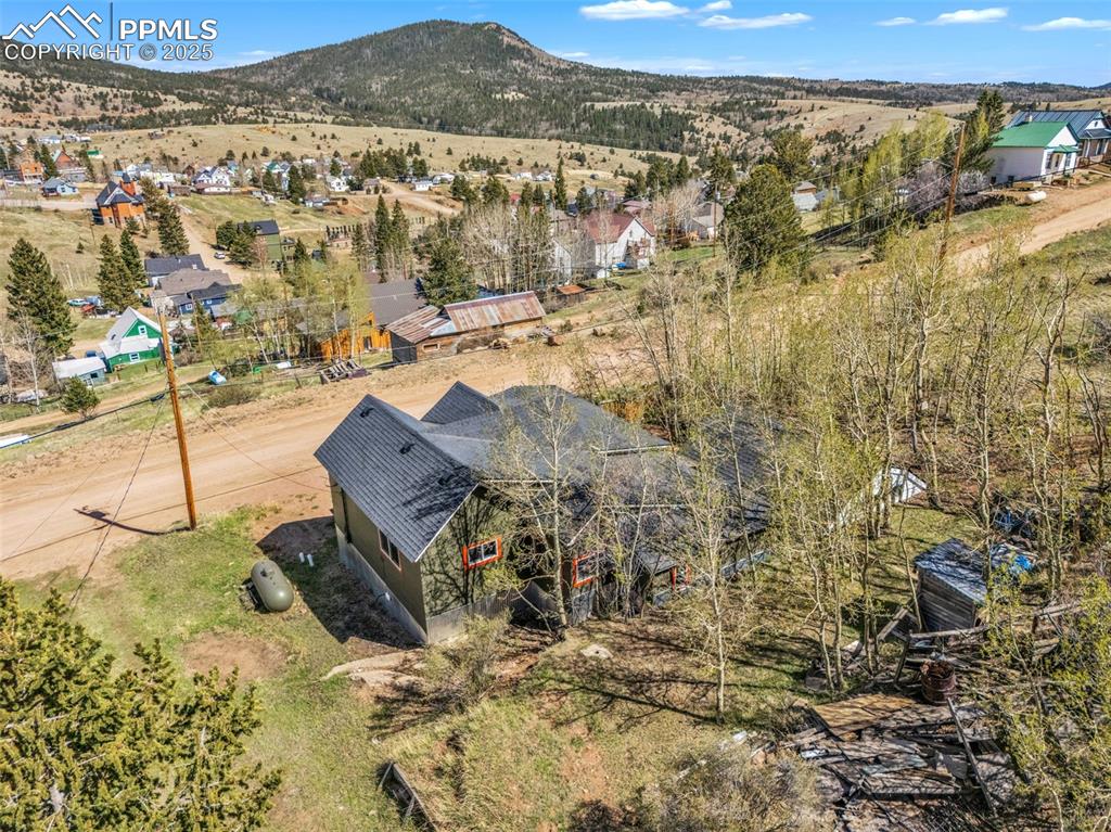 Image 5 of 50: View from above of property featuring treed lot and views of Victor and adj