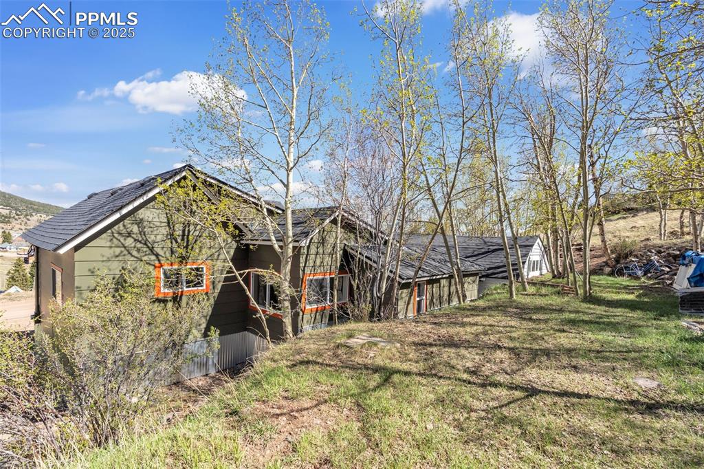 Image 6 of 50: Rear view of house with a upper garden area