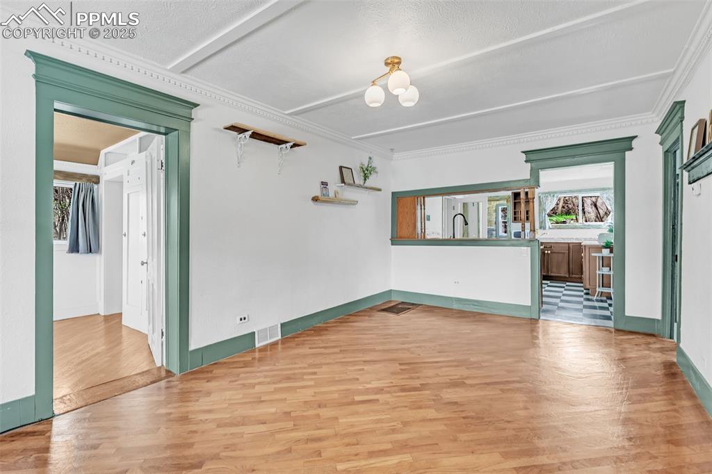 Image 8 of 50: View of living room from front entry. Main bedroom on the left and adjacen