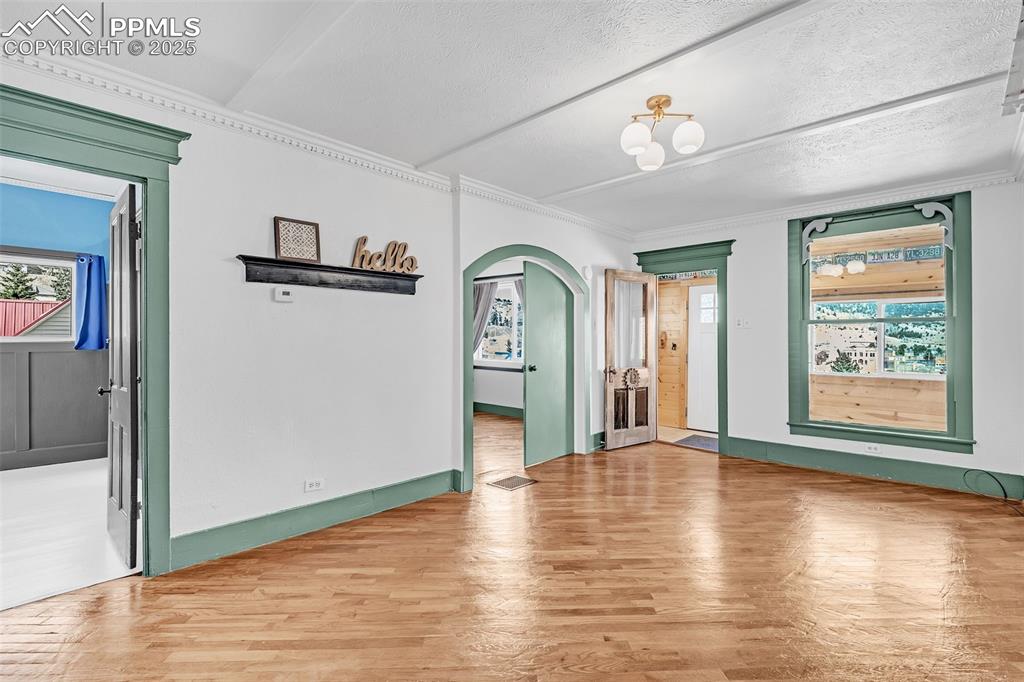 Image 9 of 50: Living room facing front door and 2nd and 3rd bedroom