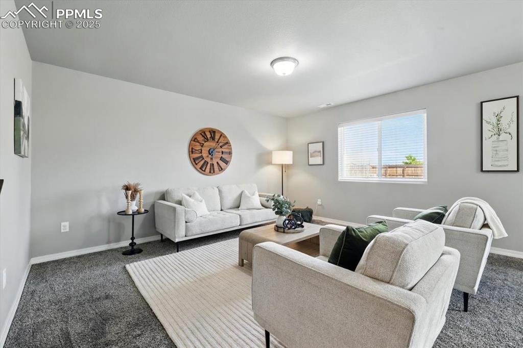 Image 13 of 45: Living room with carpet flooring