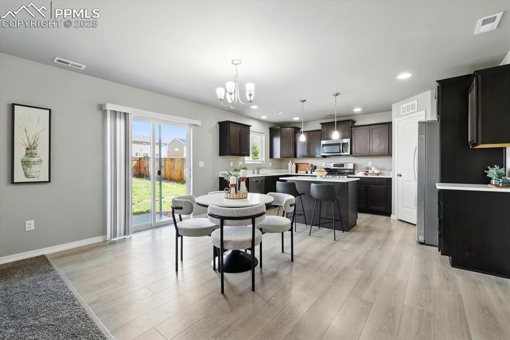 Image 14 of 45: Dining room featuring light wood-style floors, a chandelier, and recessed l