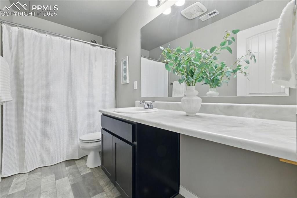 Image 33 of 45: Bathroom featuring vanity and a shower with shower curtain