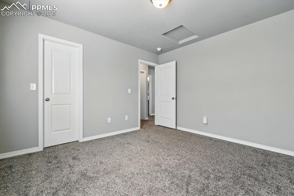 Image 34 of 45: Unfurnished bedroom with carpet flooring and baseboards