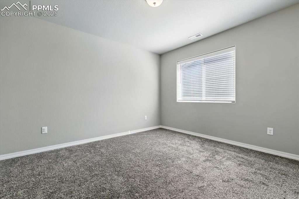 Image 35 of 45: Spare room with carpet floors and baseboards