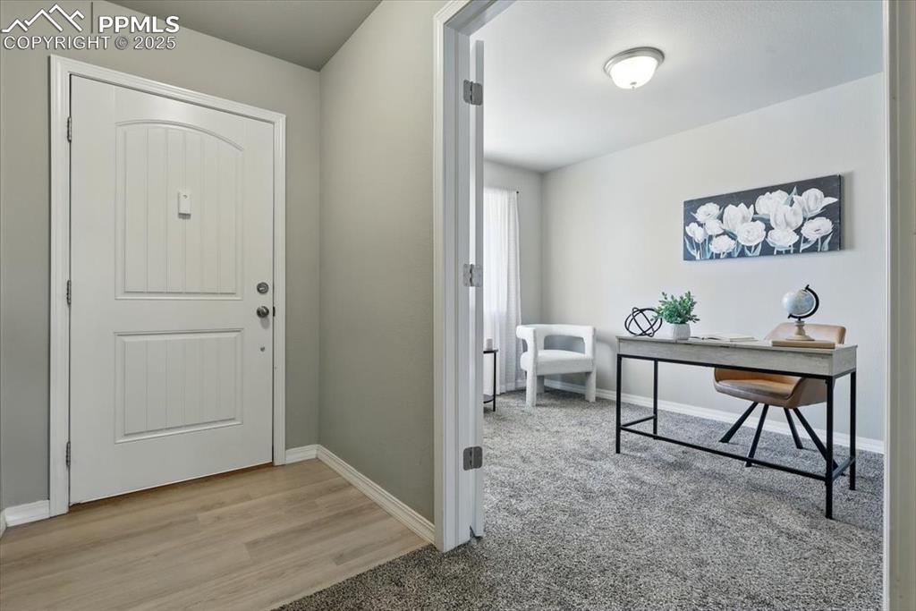 Image 4 of 45: Entrance foyer with baseboards and wood finished floors