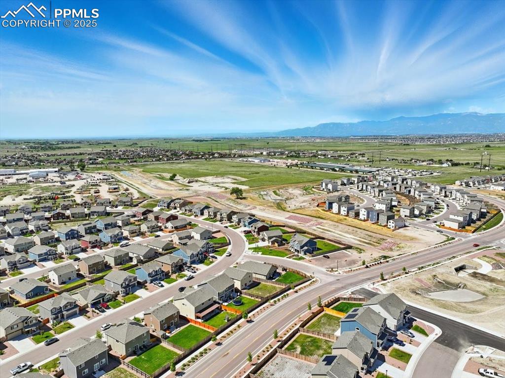 Image 44 of 45: View of property location with a mountain backdrop and nearby suburban area
