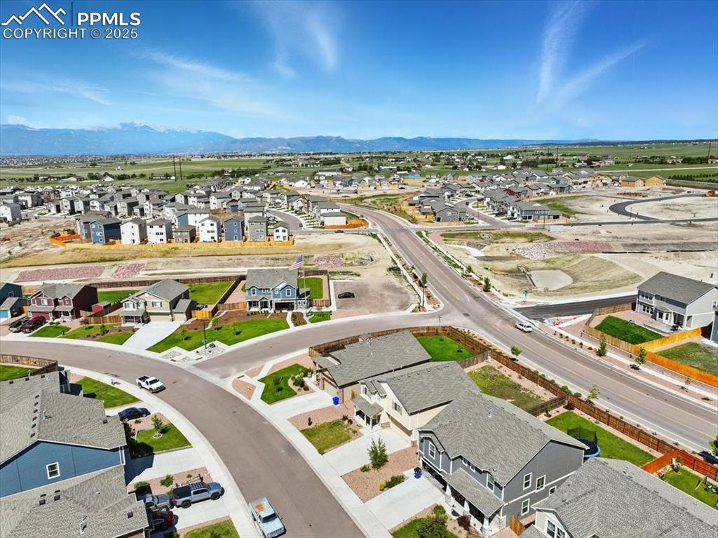 Image 45 of 45: Aerial perspective of suburban area featuring a mountain backdrop