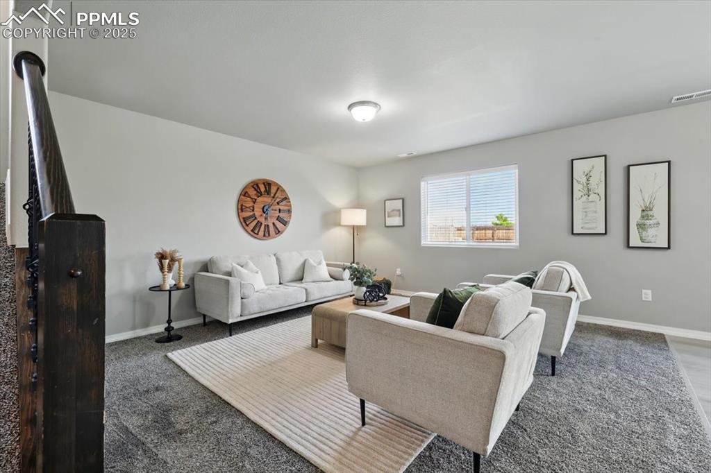 Image 9 of 45: Living room with carpet floors and baseboards