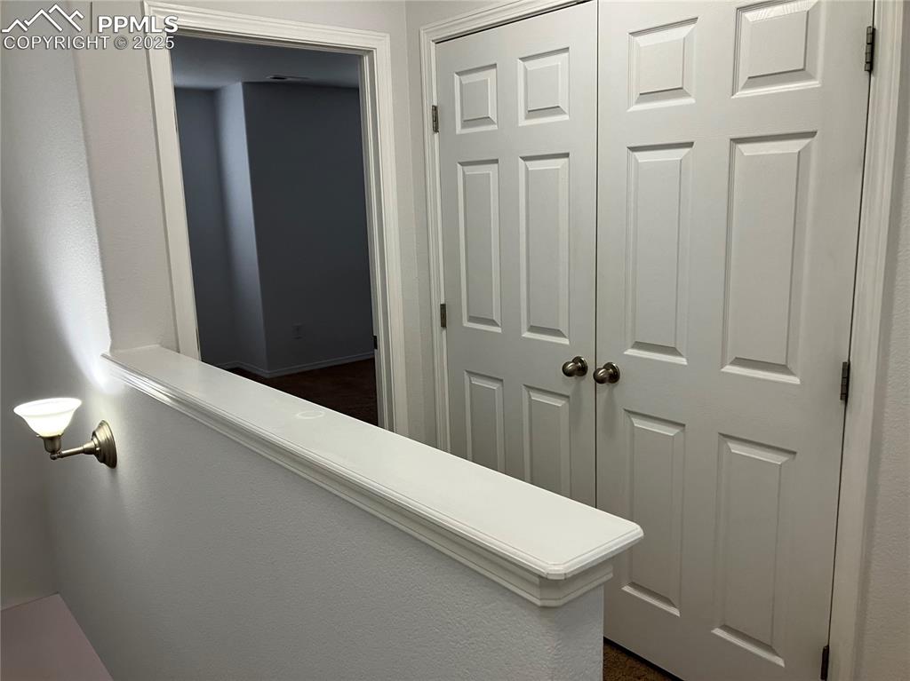 Image 10 of 18: Upper hallway and laundry area
