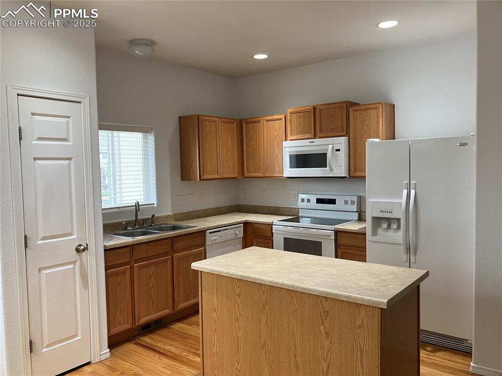 Image 5 of 18: Island with storage, hardwood floors