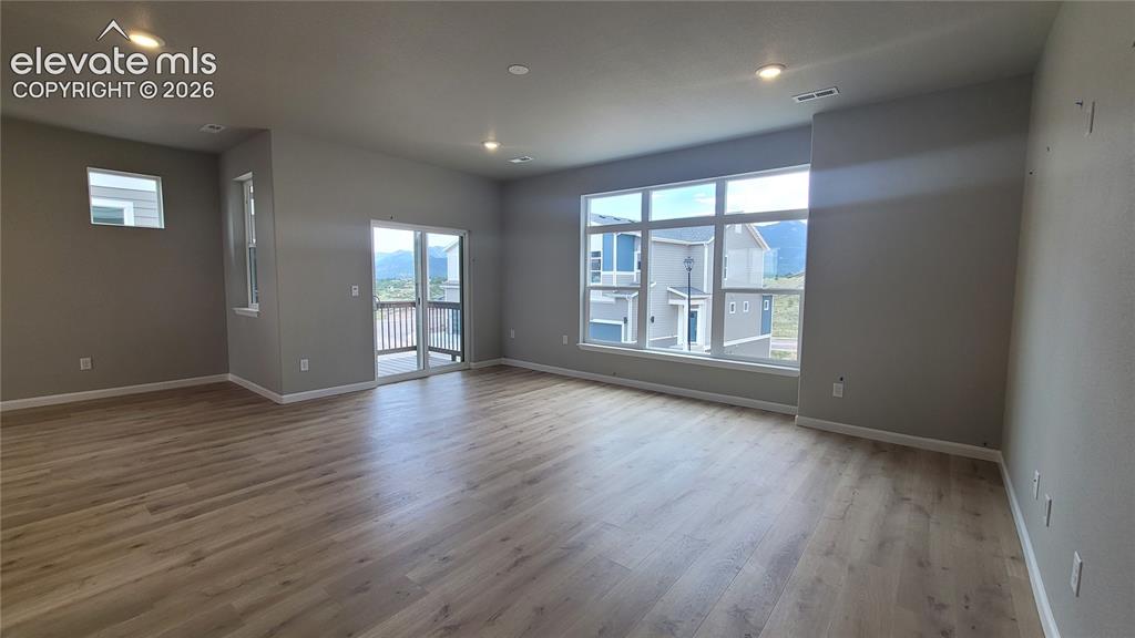 Image 10 of 32: Another View of Living Room with walk out to Composite Deck!