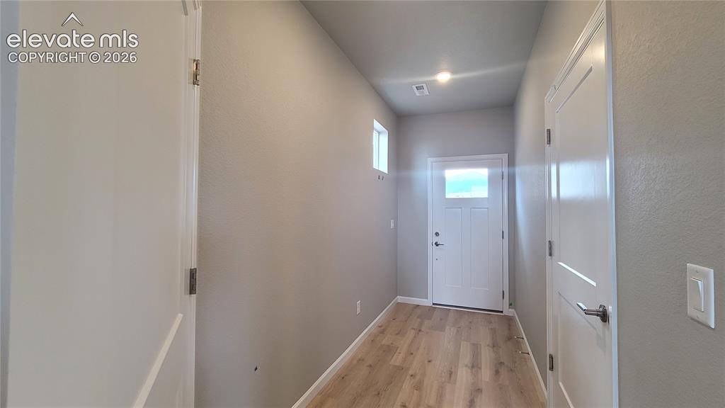 Image 3 of 32: Inviting Entryway with LVP flooring, access to 2-car garage, utility closet