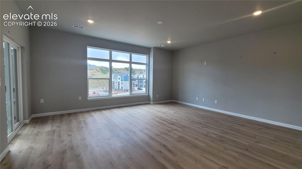 Image 9 of 32: Living Room with LVP flooring, LED lighting, pre-wired for future fan, abun