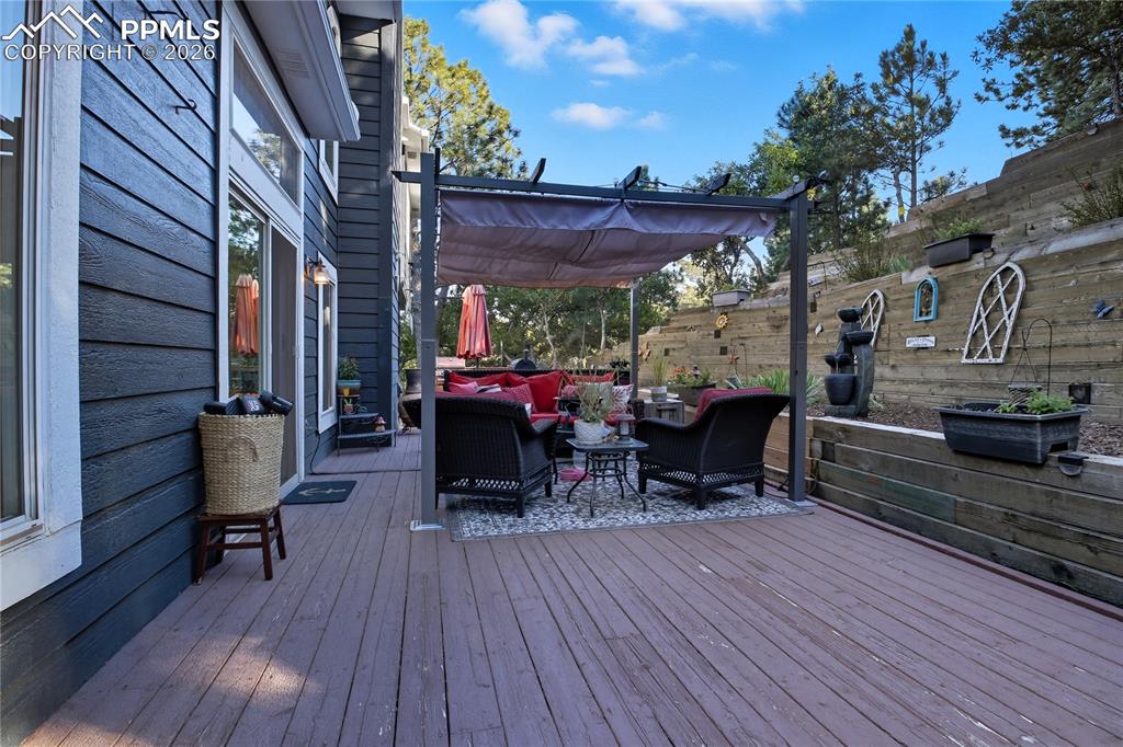 Image 12 of 45: Wooden terrace with outdoor lounge area