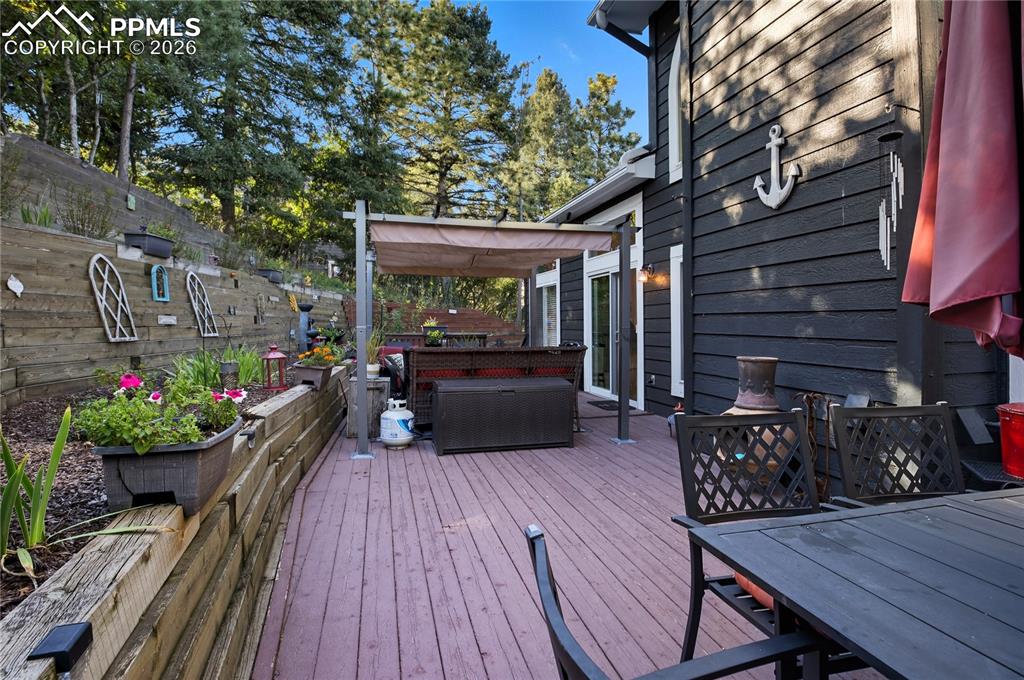 Image 13 of 45: Deck with an outdoor living / dining area