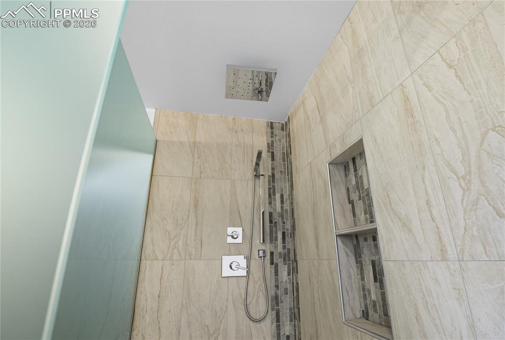 Image 28 of 45: Bathroom with a tile shower