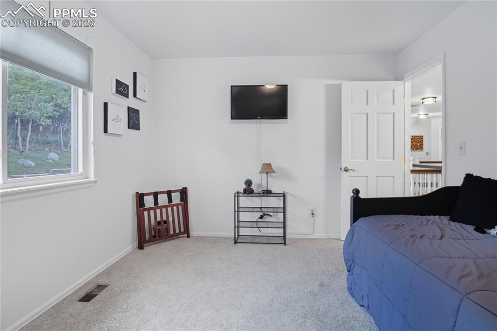 Image 34 of 45: Bedroom with carpet flooring and baseboards