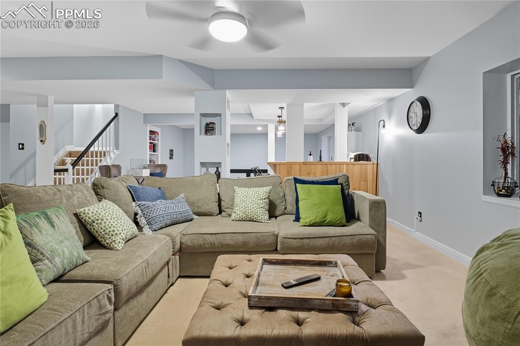 Image 39 of 45: Living room featuring carpet and ceiling fan