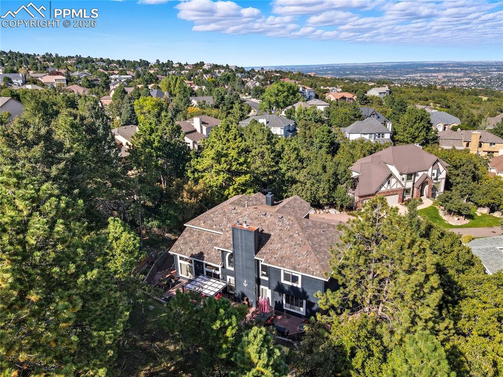 Image 40 of 45: Aerial view of residential area with a tree filled landscape