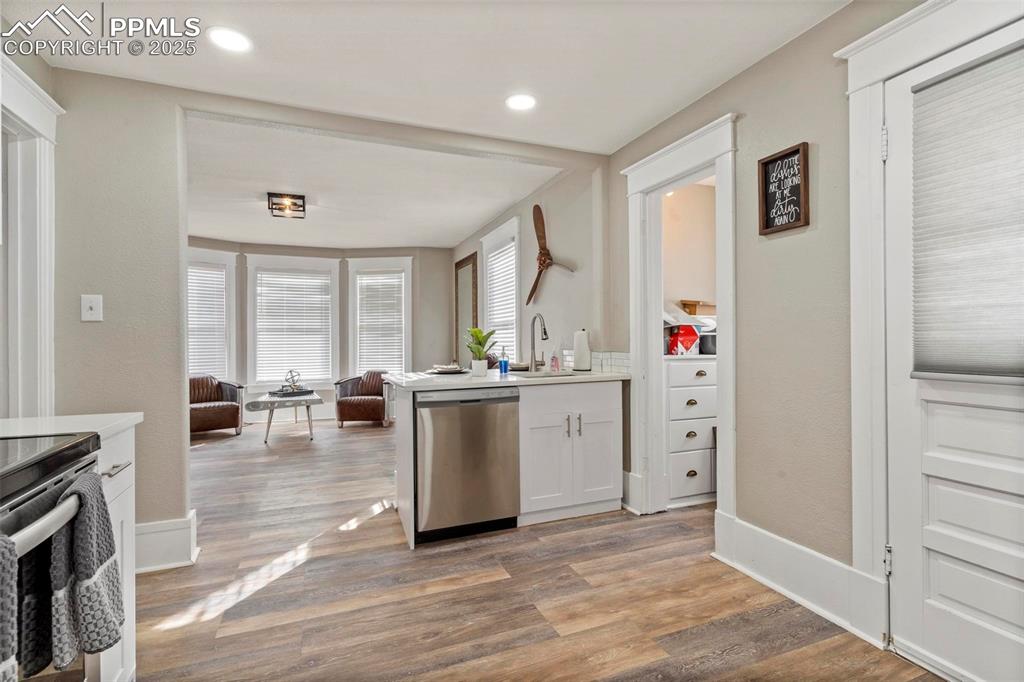 Image 13 of 43: Kitchen featuring stainless steel appliances, open floor plan, wood finishe