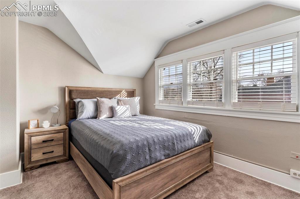 Image 22 of 43: Bedroom featuring carpet flooring, vaulted ceiling, and baseboards